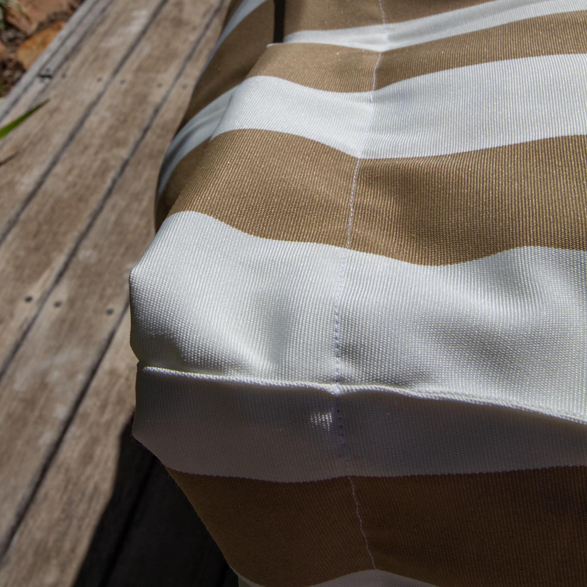 Close-up of a brown and white striped fabric on a wooden surface