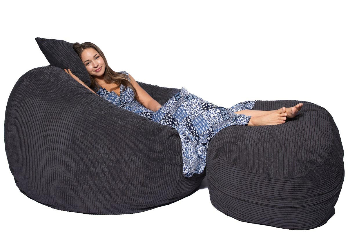 Woman reclining on large charcoal beanbag