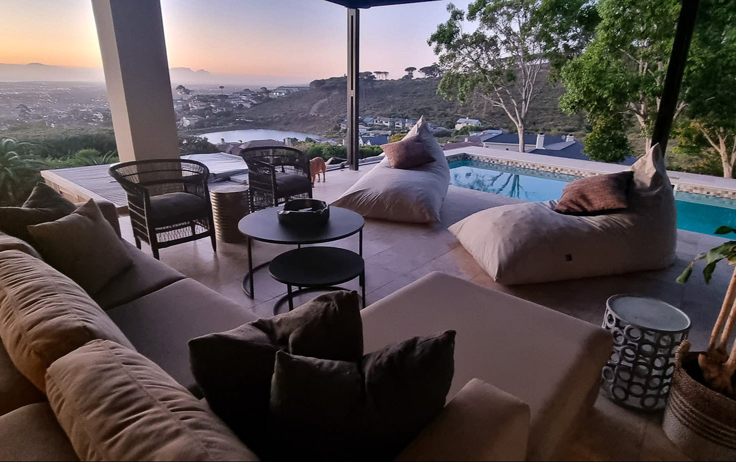 Outdoor patio area with furniture and a pool view