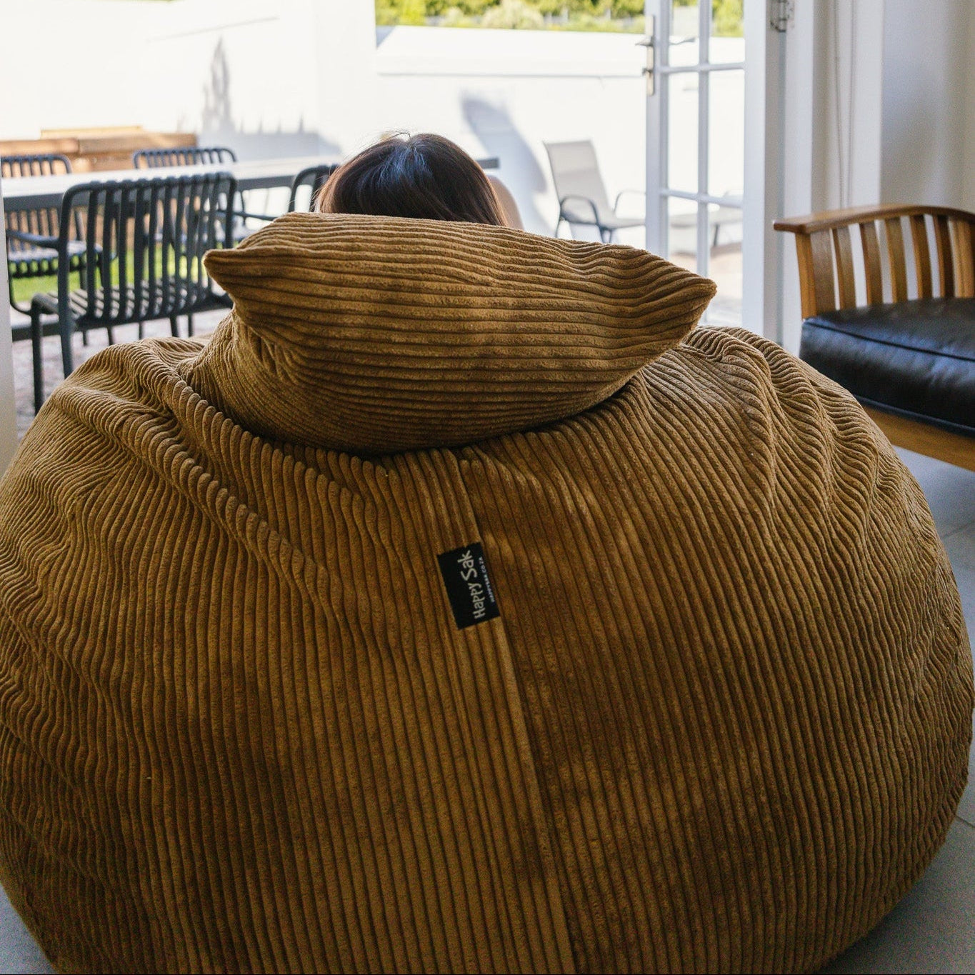 Woman sitting on light brown beanbag in Stellenbosch