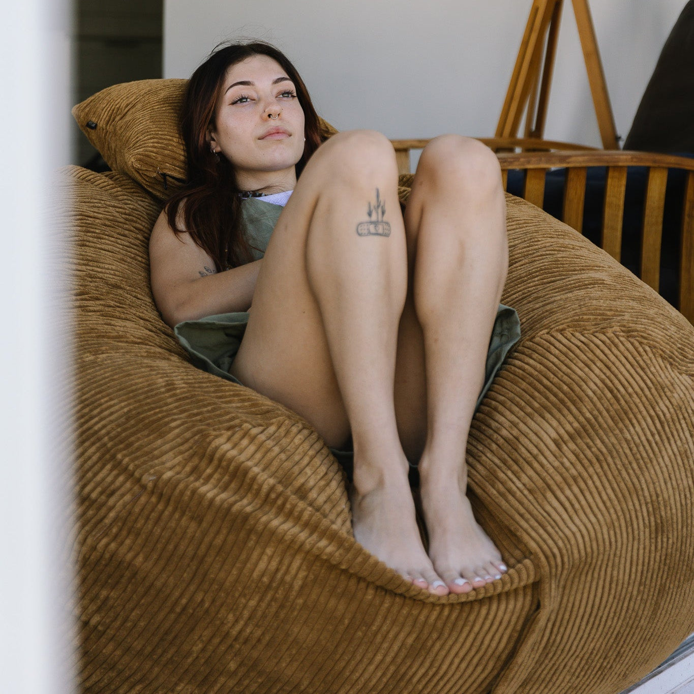 Woman reclining on brown beanbag cape town