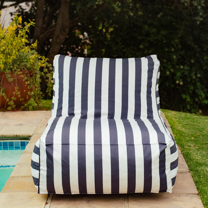 Navy and white striped chair by a poolside