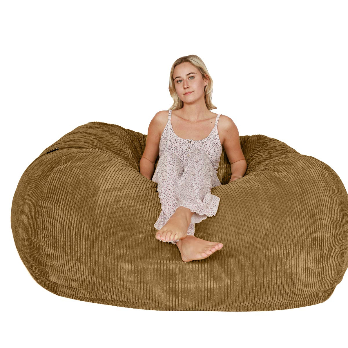 Woman sitting on a large brown bean bag chair against a white background