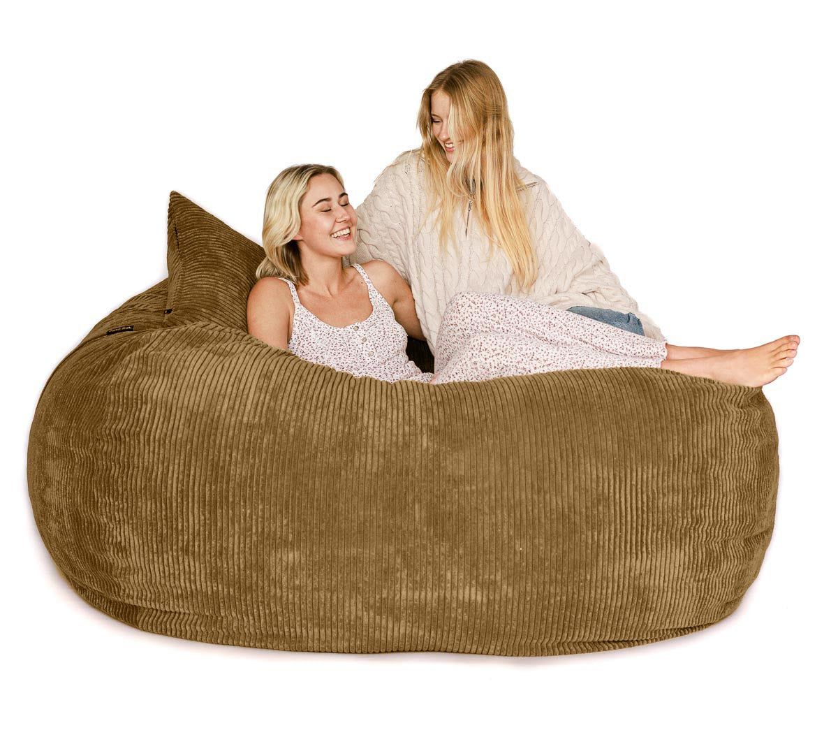 Two women sitting on a large brown bean bag chair against a white background