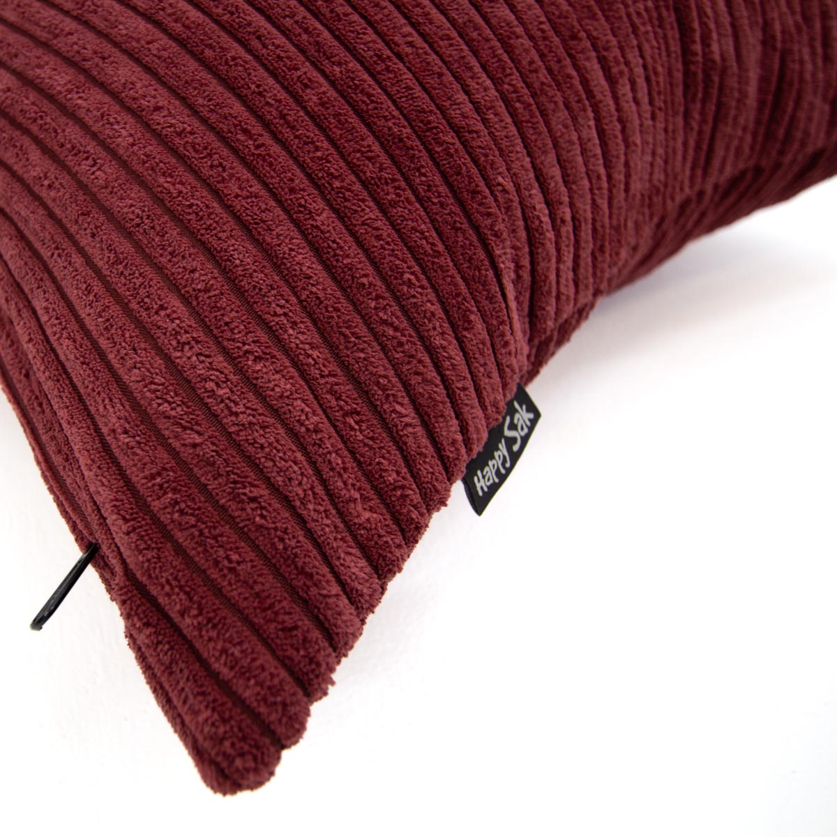 Maroon ribbed pillow with a visible brand tag on a white background