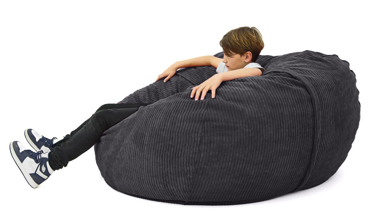 boy sitting on large charcoal corduroy beanbag