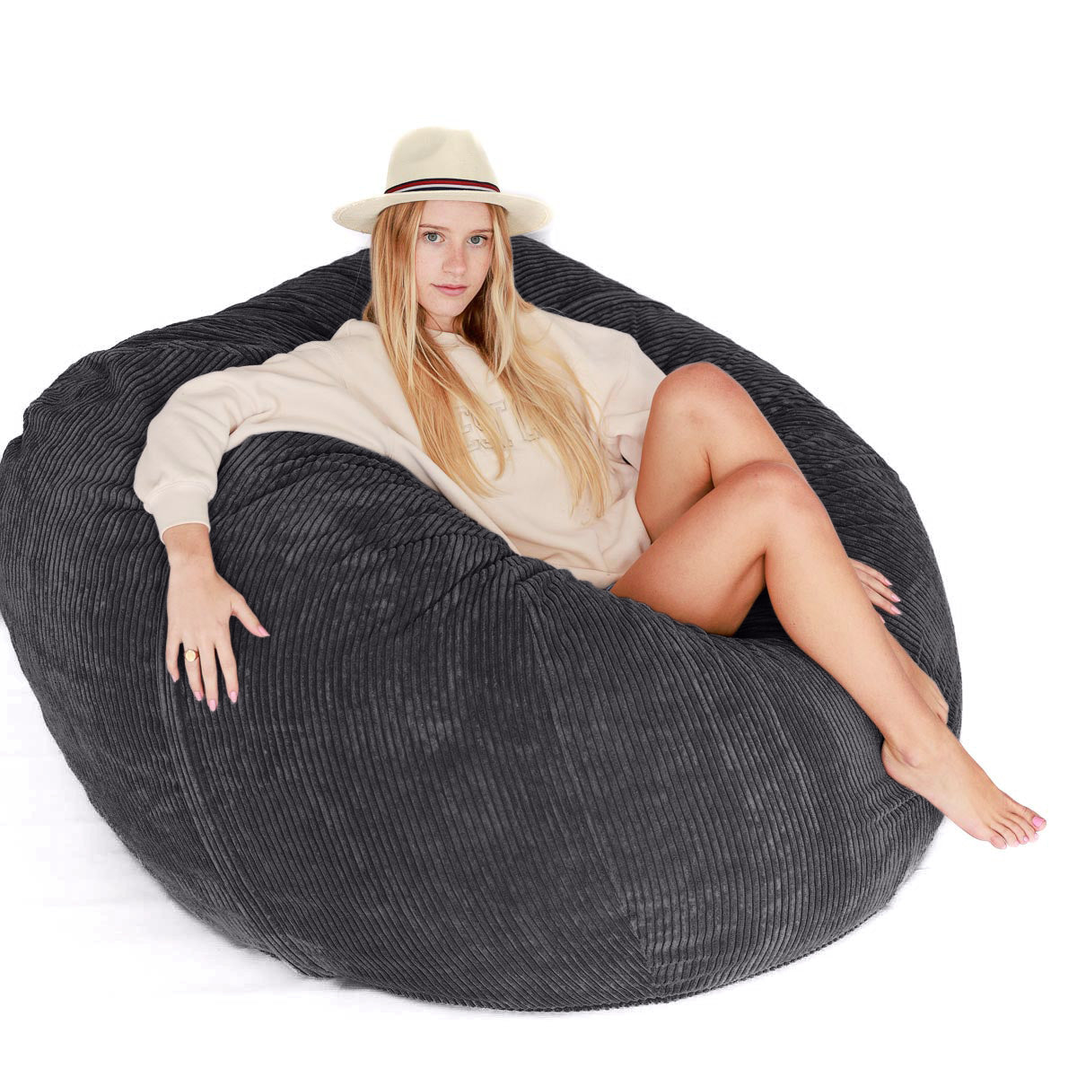 Woman sitting on large charcoal corduroy beanbag
