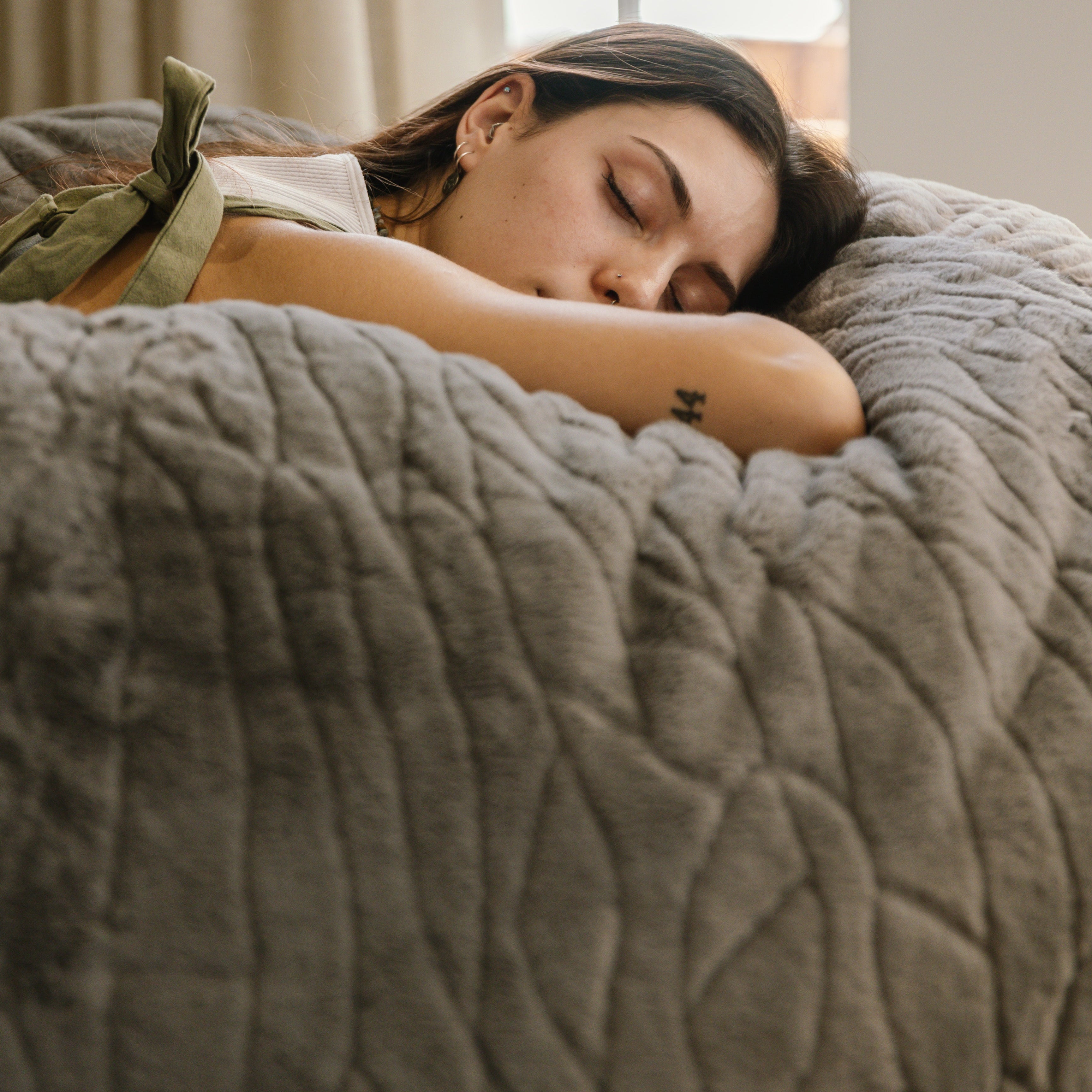 Woman sleeping on large faux fur beanbag