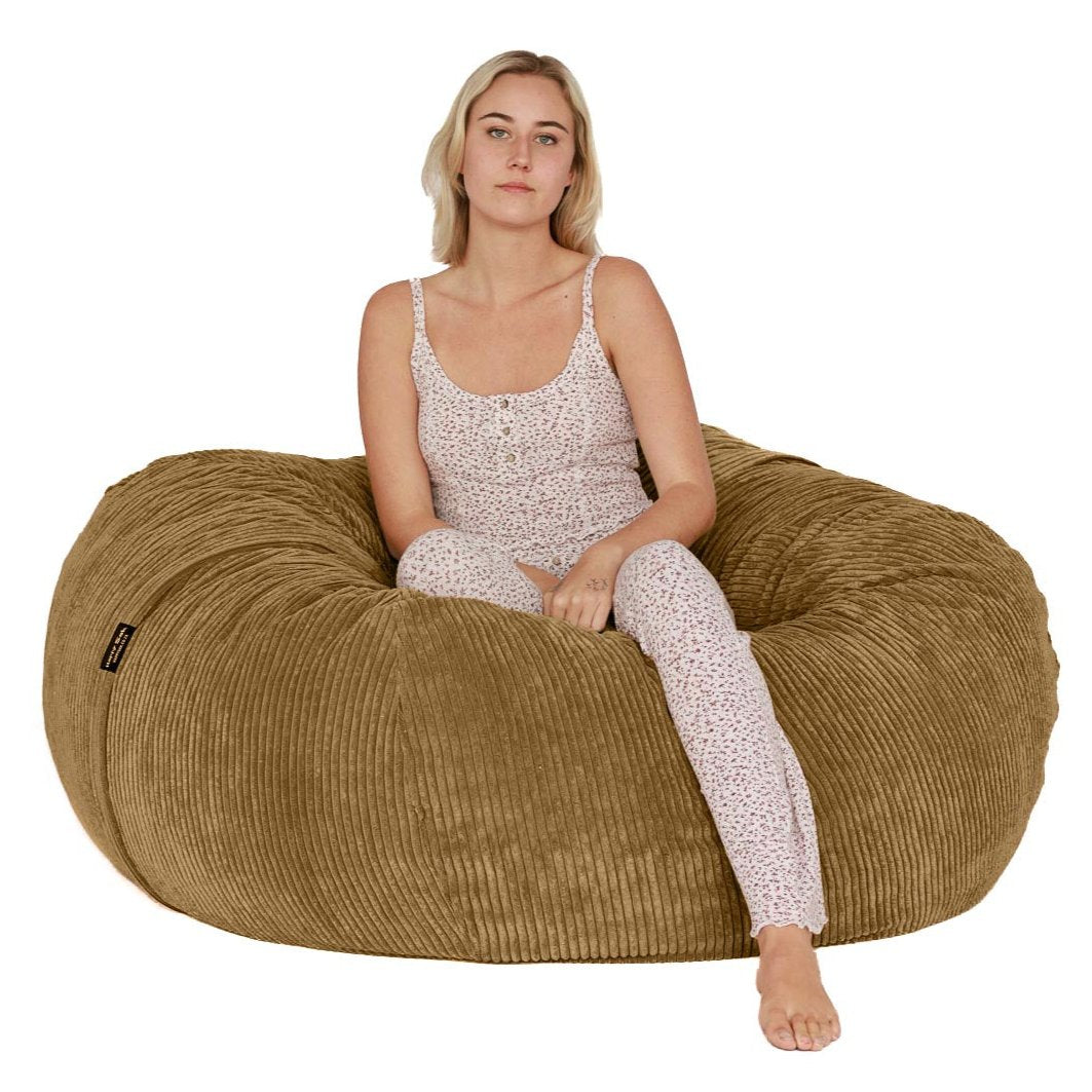 woman sitting on medium brown beanbag