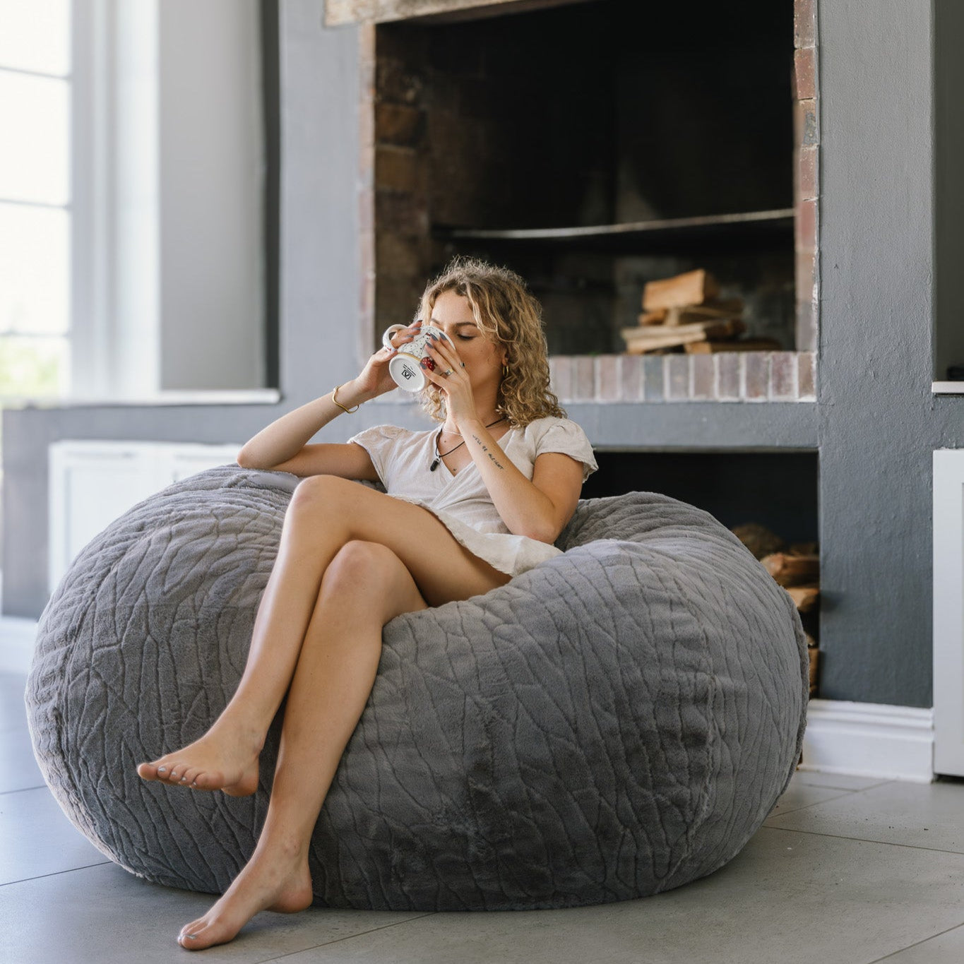 woman sitting on faux fur beanbag