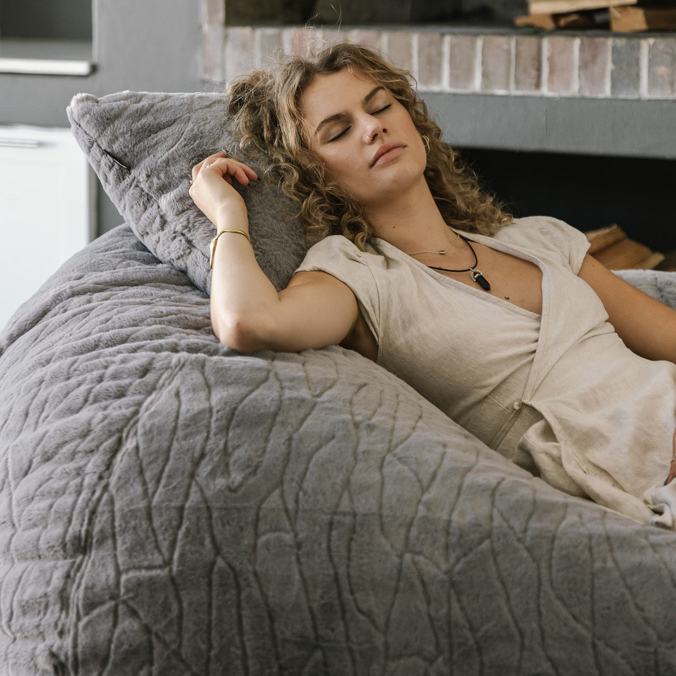 Woman reclining on faux fur beanbag