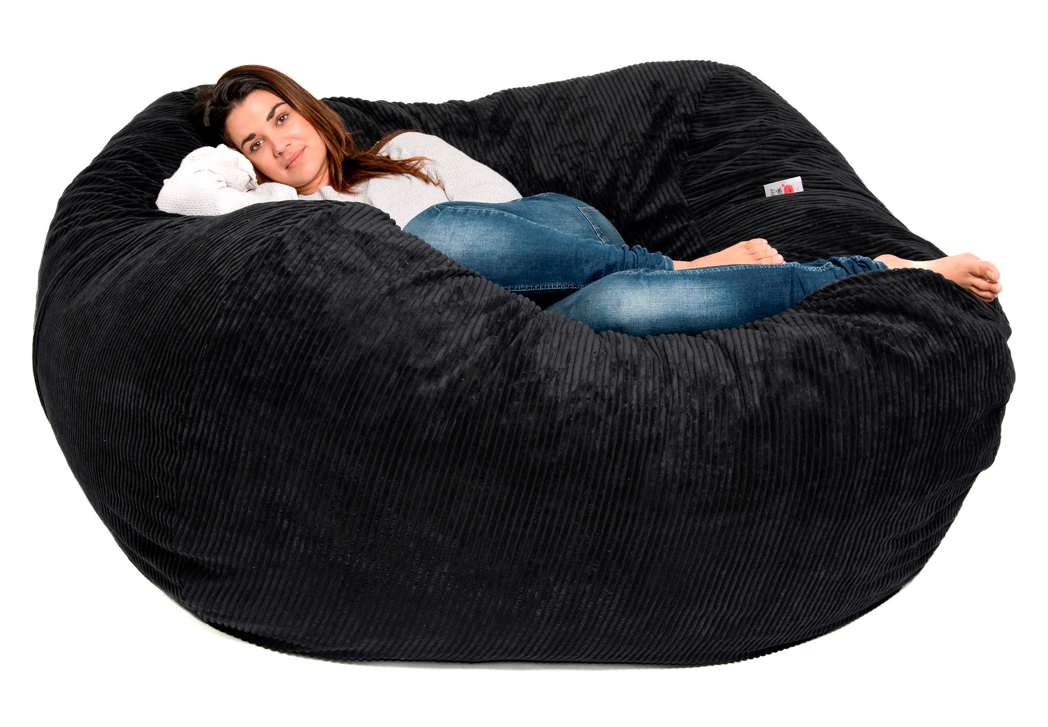 girl on black bean bag on white background