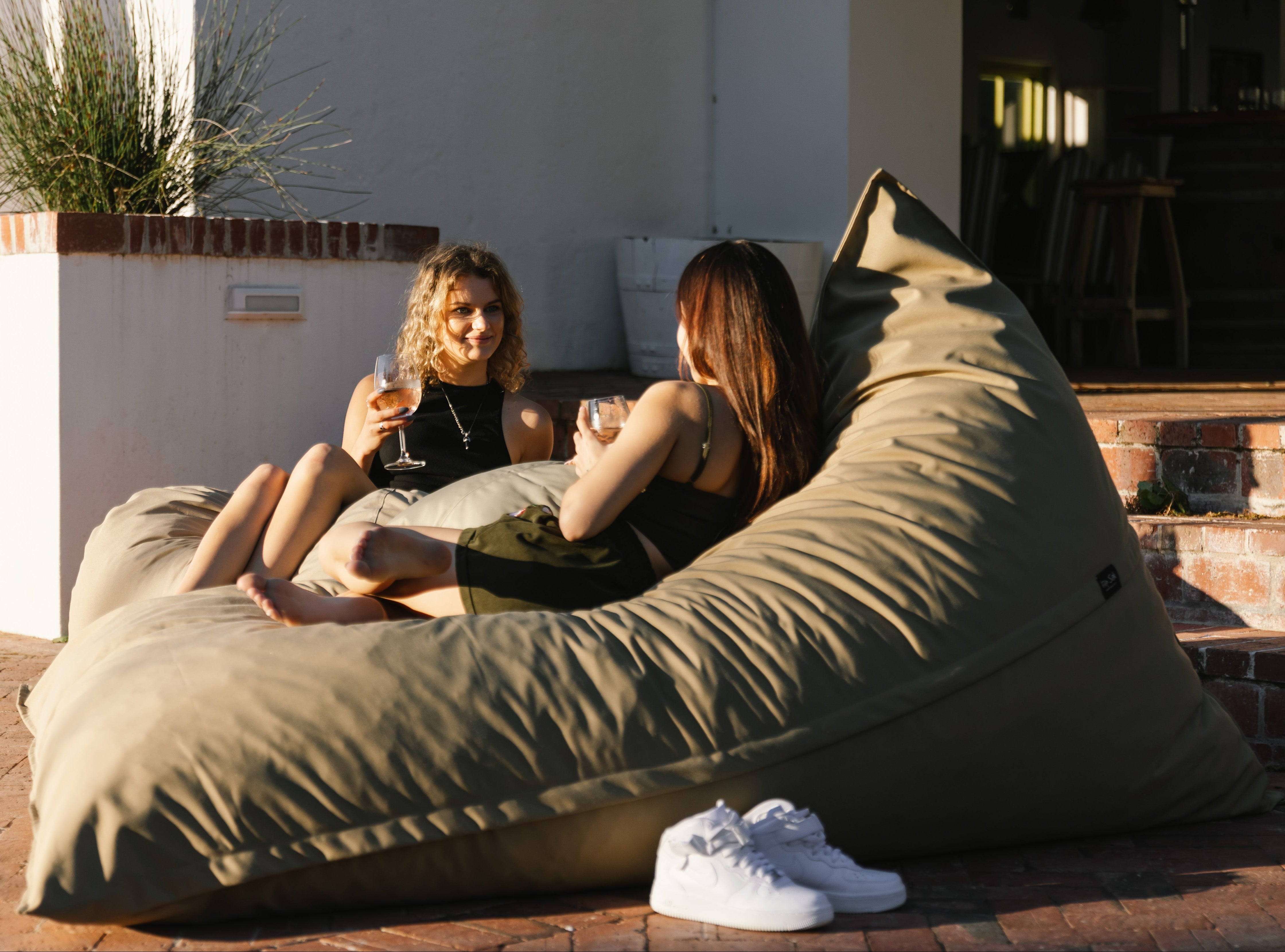girls drinking wine on outdoor bean bags