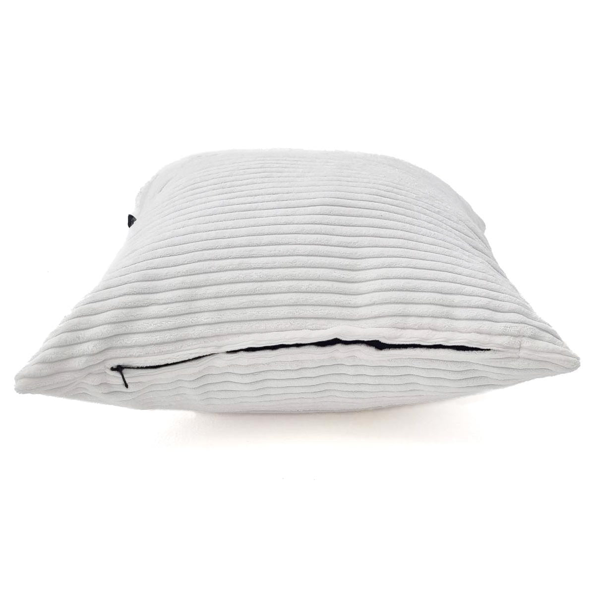 White pillow with black trim on a white background