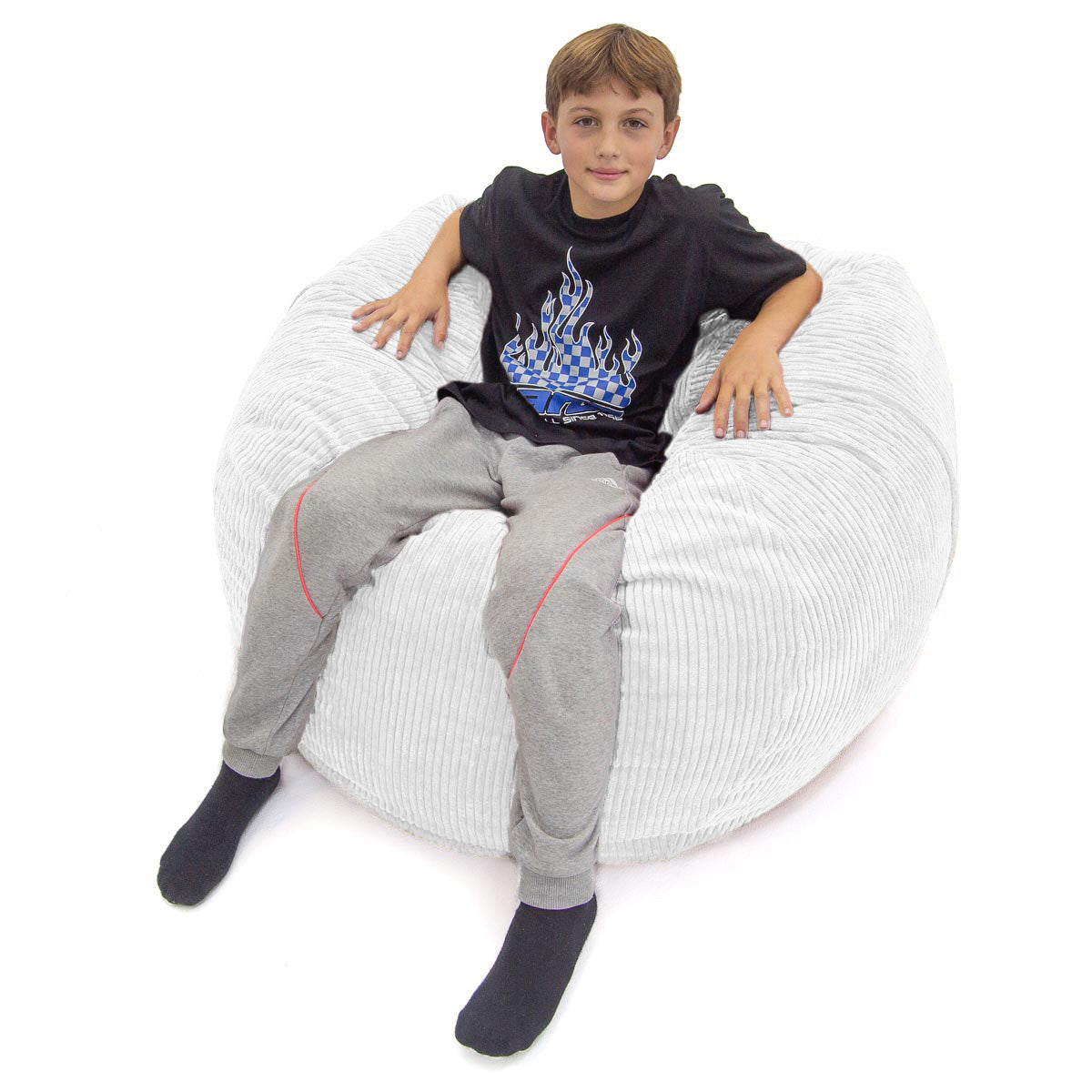 Child sitting on a white bean bag chair with a plain background