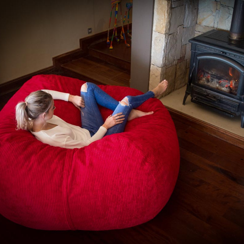 person lounging on a red bean bag