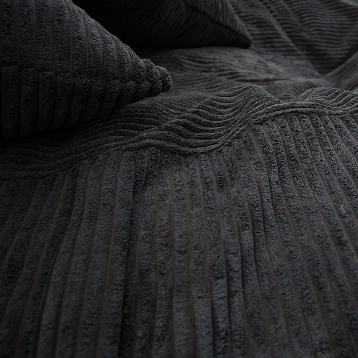 Dark gray textured fabric with a pillow