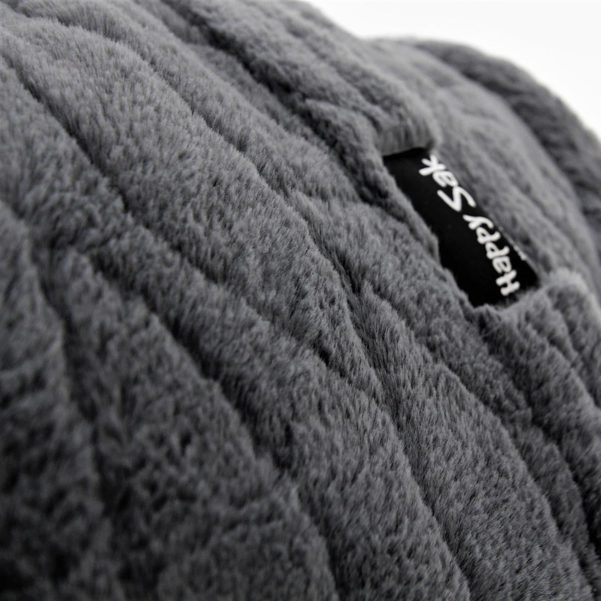 Gray textured faux fur fabric with a visible brand label on a white background