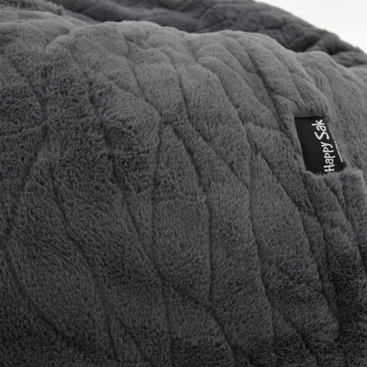 Textured gray faux fur with a brand label on a gray background