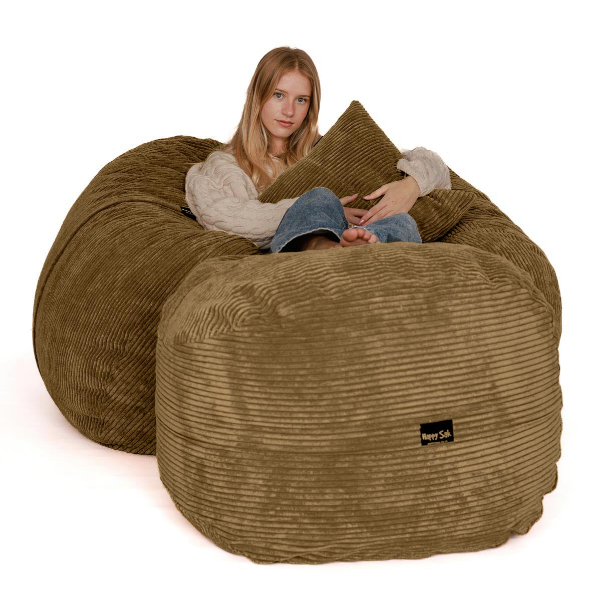 Woman sitting on a large brown bean bag chair with a white background