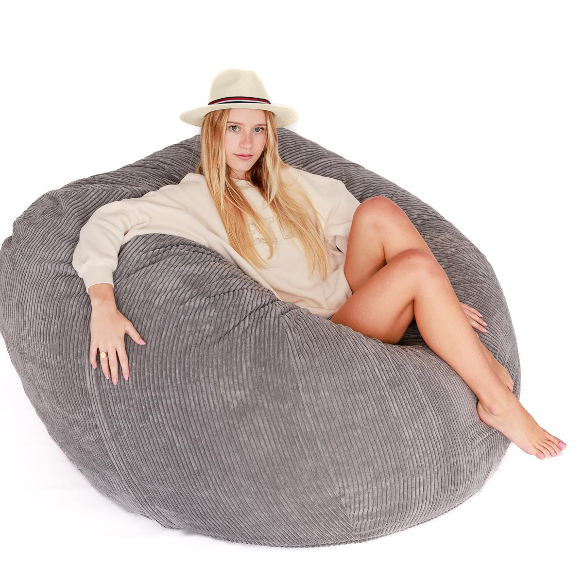 woman sitting on grey bean bag chair 