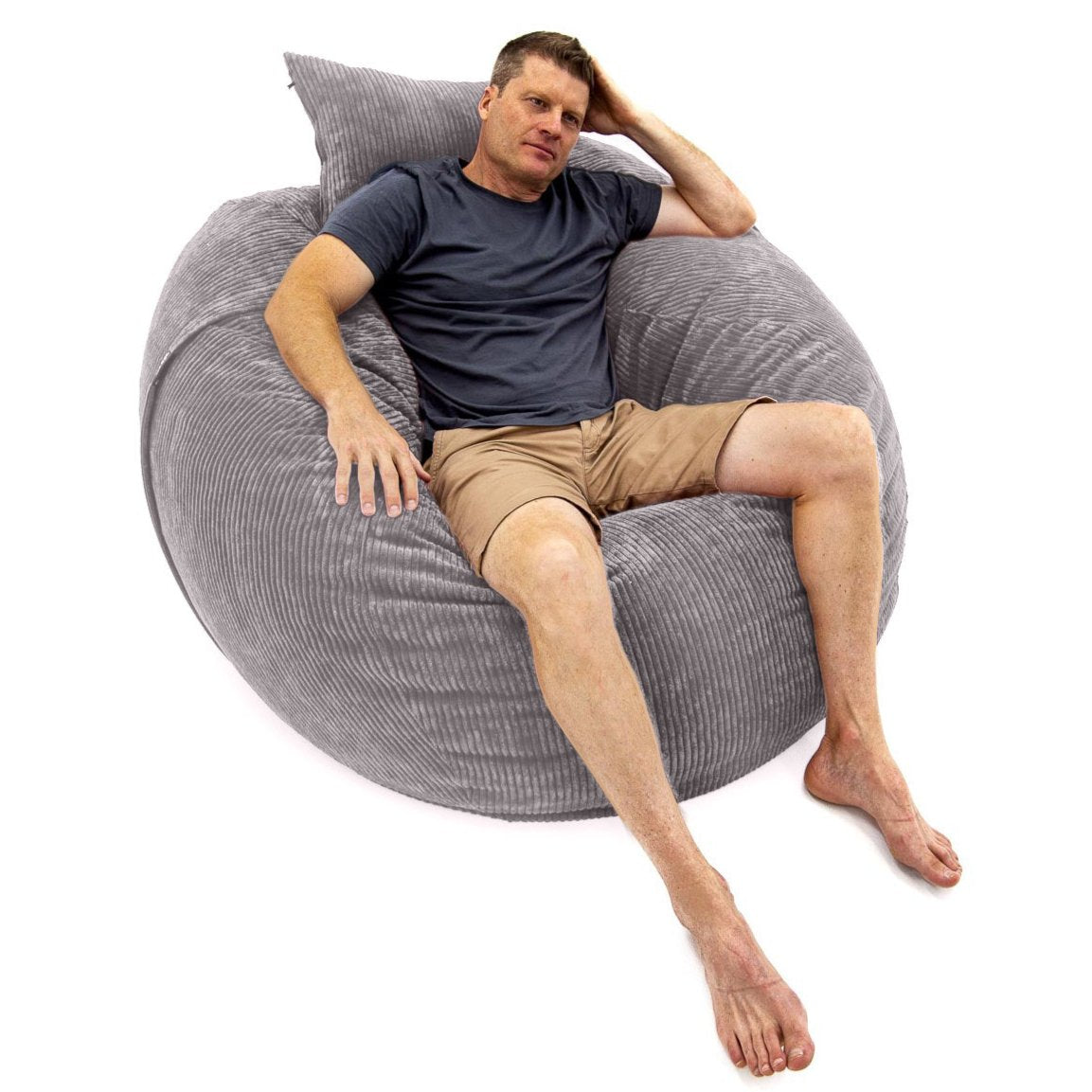 A person relaxing on a large gray corduroy bean bag chair.