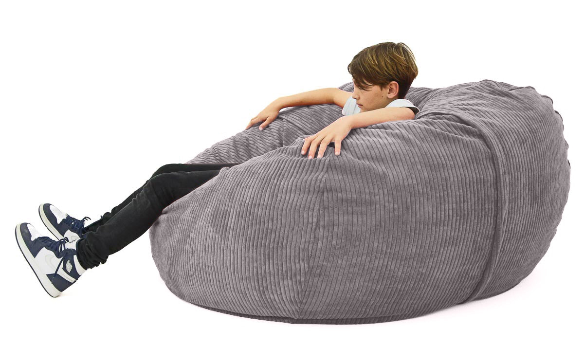 boy sitting on grey cord bean bag
