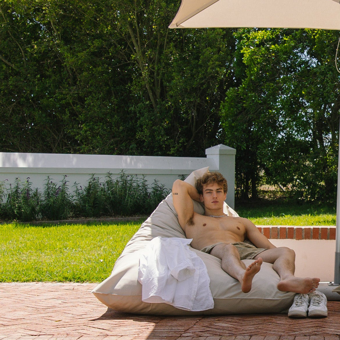 man on an outdoor bean bag