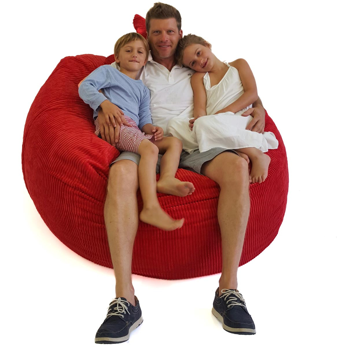 Man with two children sitting on a red bean bag chair against a white background