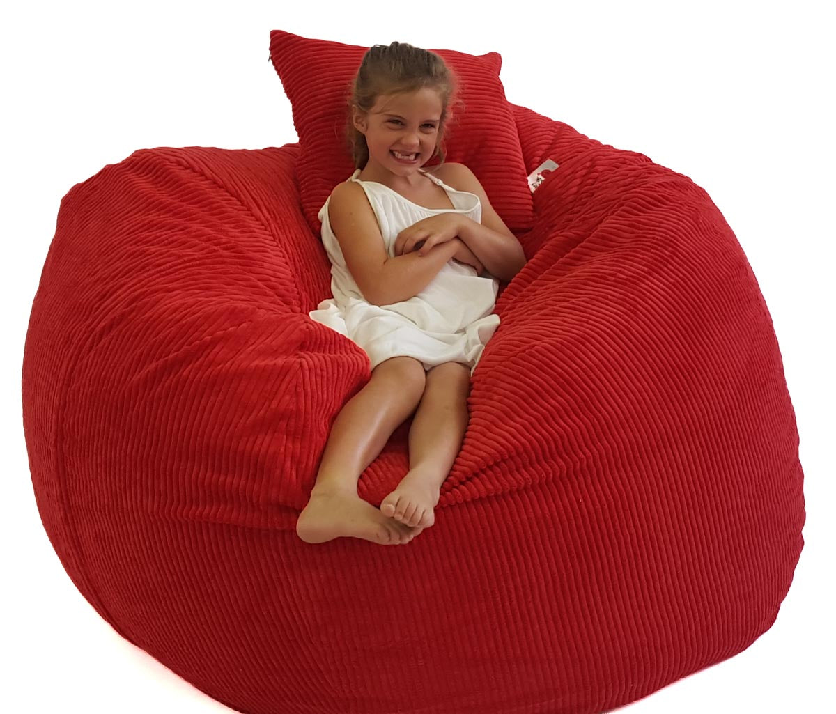 Child sitting on a large red bean bag chair with a white background